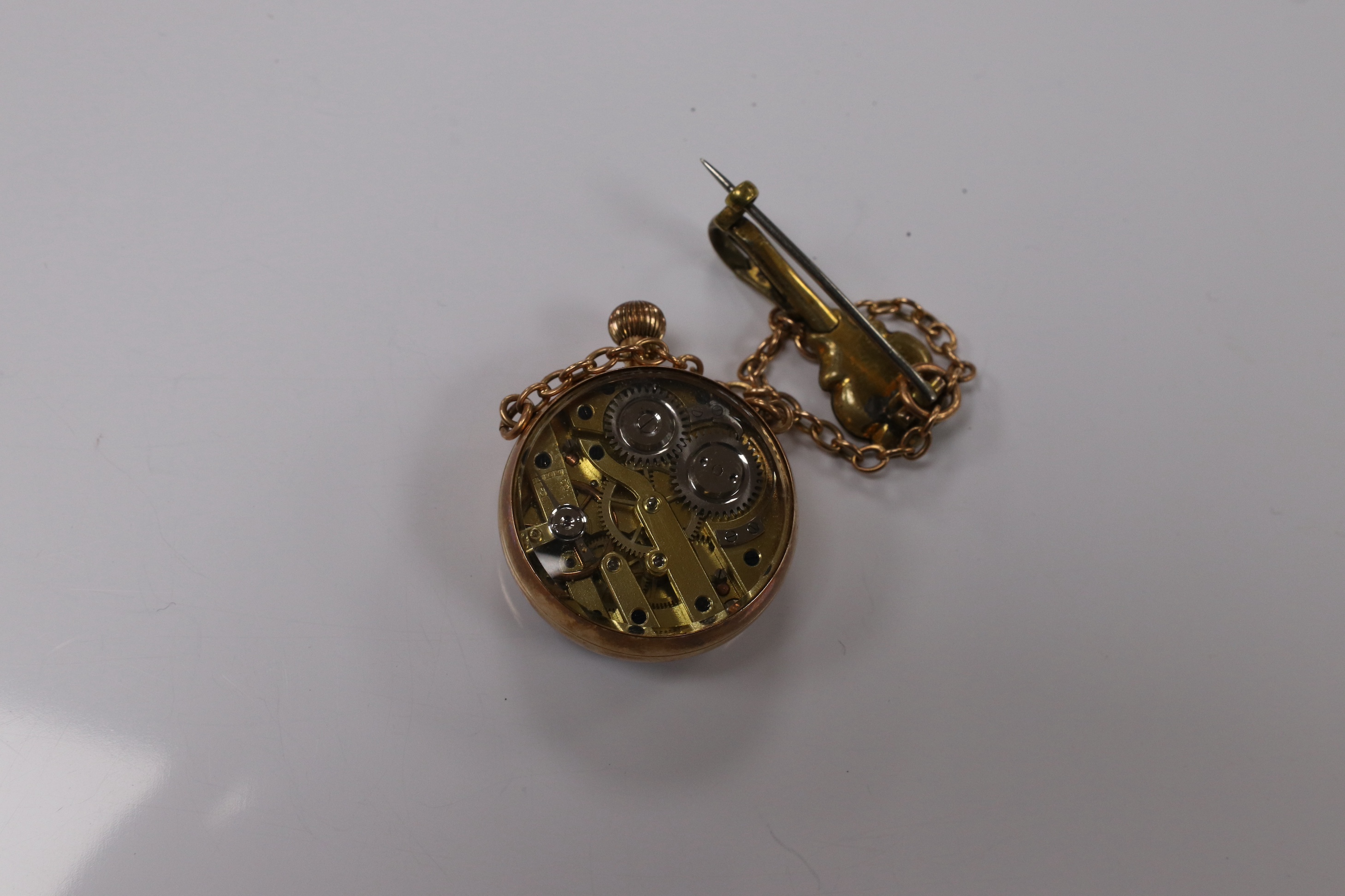 A lady's yellow metal mounted fob watch, with Roman dial and suspension chain with brooch, case diameter 26mm. Condition - fair